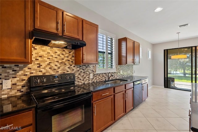 6068 Triumph Ln, Ave Maria, FL 34142 - kitchen with visible vents, black appliances, under cabinet range hood, a sink, and light tile patterned flooring
