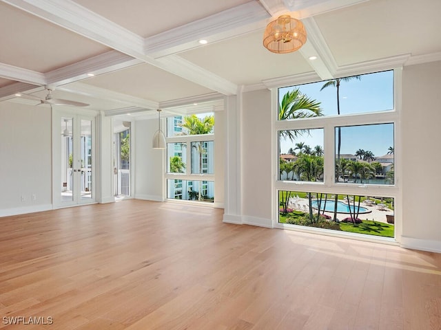 unfurnished living room with beam ceiling, ornamental molding, coffered ceiling, and wood finished floors