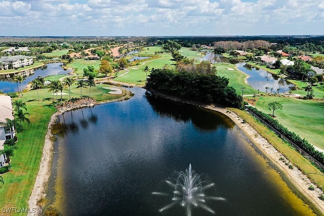 birds eye view of property with view of golf course and a water view