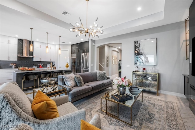 28078 Captiva Shell Loop, Bonita Springs, FL 34135 - living room featuring arched walkways, a chandelier, baseboards, recessed lighting, and light marble finish floors