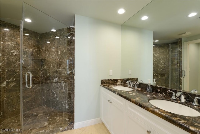 1490 5th Ave S Unit 200B, Naples, FL 34102 - full bathroom with a stall shower, recessed lighting, double vanity, tile patterned flooring, and baseboards
