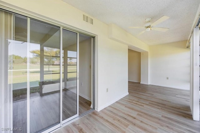 315 Saint Andrews Blvd Unit D5, Naples, FL 34113 - unfurnished room with light wood finished floors, a textured ceiling, baseboards, visible vents, and ceiling fan