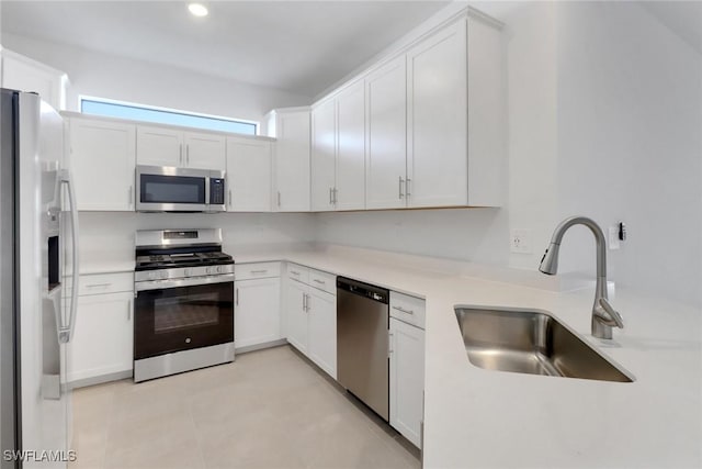 19513 Hinkley Dr, Estero, FL 33928 - kitchen featuring a sink, white cabinetry, light countertops, and appliances with stainless steel finishes