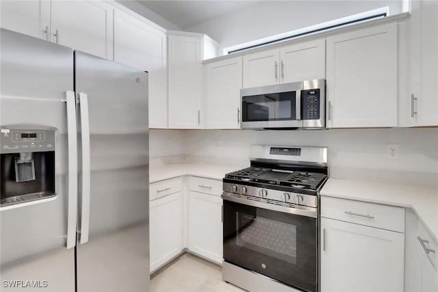 19513 Hinkley Dr, Estero, FL 33928 - kitchen with light countertops, white cabinets, and stainless steel appliances