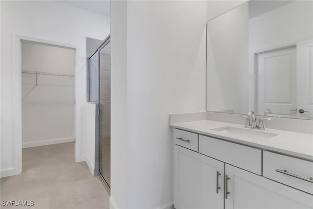 19513 Hinkley Dr, Estero, FL 33928 - full bath with vanity, baseboards, a spacious closet, and a shower stall