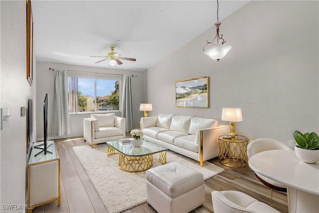 living area with ceiling fan and wood finished floors