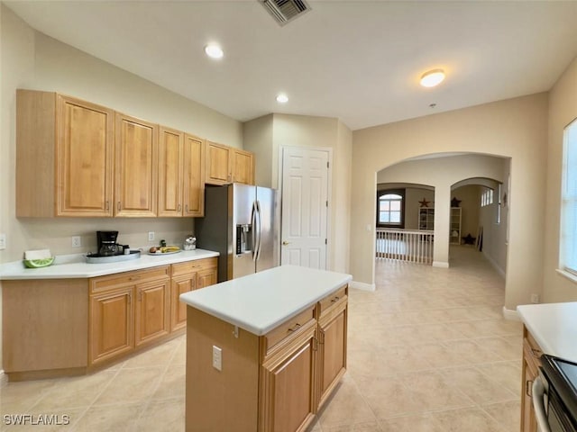 5956 Tarpon Gardens Cir Unit 201, Cape Coral, FL 33914 - kitchen featuring visible vents, electric range, arched walkways, light countertops, and stainless steel fridge