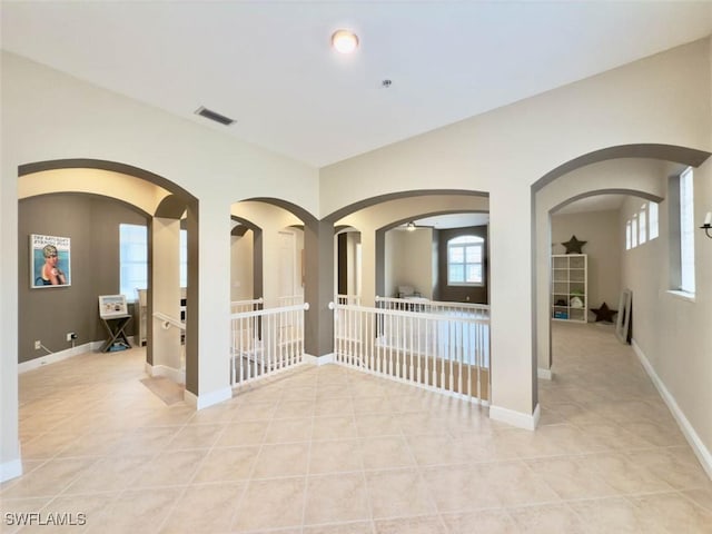 5956 Tarpon Gardens Cir Unit 201, Cape Coral, FL 33914 - unfurnished room with light tile patterned floors, visible vents, baseboards, and arched walkways