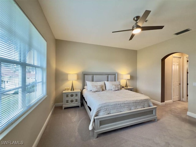 5956 Tarpon Gardens Cir Unit 201, Cape Coral, FL 33914 - carpeted bedroom featuring visible vents, arched walkways, baseboards, and ceiling fan