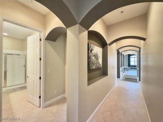 5956 Tarpon Gardens Cir Unit 201, Cape Coral, FL 33914 - hall with tile patterned floors, baseboards, and arched walkways