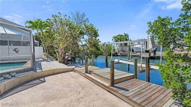 411 Connecticut St, Fort Myers Beach, FL 33931 - dock with a water view, boat lift, glass enclosure, and an outdoor pool