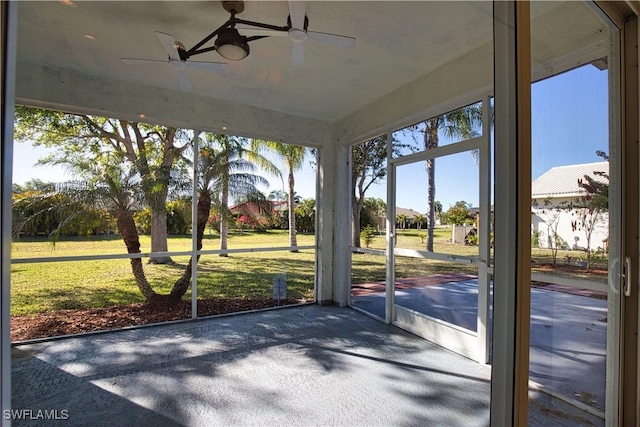 1675 Blue Lake Cir, Punta Gorda, FL 33983 - unfurnished sunroom featuring ceiling fan and unfinished concrete floors