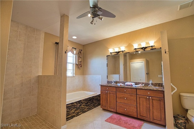 1675 Blue Lake Cir, Punta Gorda, FL 33983 - bathroom featuring tile patterned flooring, toilet, double vanity, a bath, and a ceiling fan