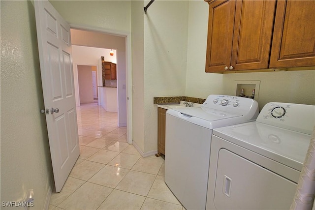 1675 Blue Lake Cir, Punta Gorda, FL 33983 - laundry area featuring light tile patterned floors, baseboards, cabinet space, and independent washer and dryer