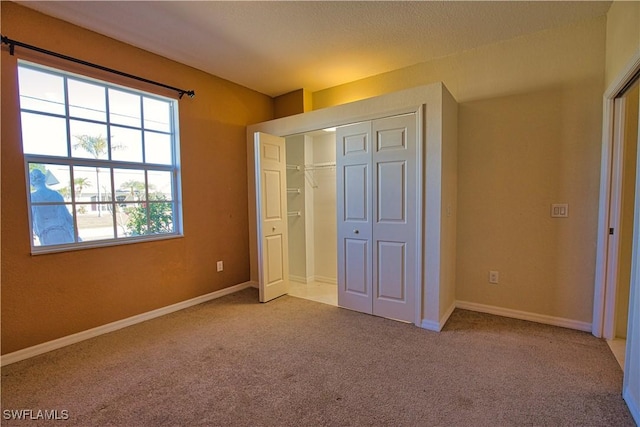 1675 Blue Lake Cir, Punta Gorda, FL 33983 - unfurnished bedroom with carpet, a closet, and baseboards