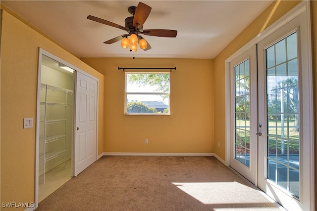 1675 Blue Lake Cir, Punta Gorda, FL 33983 - unfurnished bedroom with french doors, baseboards, access to exterior, and carpet flooring