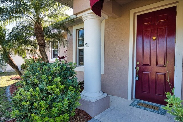 1675 Blue Lake Cir, Punta Gorda, FL 33983 - doorway to property featuring stucco siding
