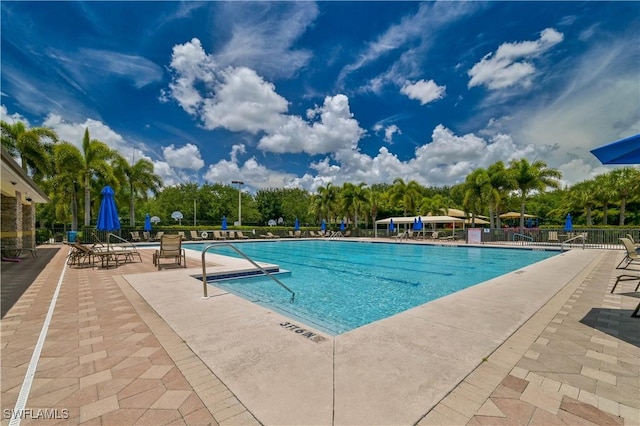 pool featuring fence and a patio