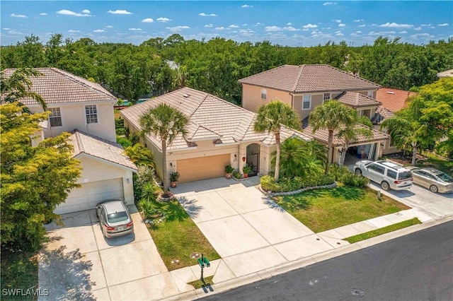 birds eye view of property featuring a wooded view