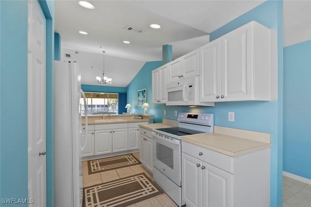 4970 Deerfield Way Unit F202, Naples, FL 34110 - kitchen with white appliances, a sink, light tile patterned floors, white cabinetry, and vaulted ceiling