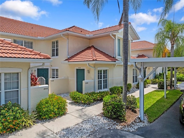 4970 Deerfield Way Unit F202, Naples, FL 34110 - mediterranean / spanish home featuring a tiled roof and stucco siding