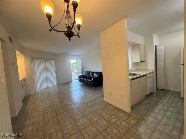 177 Santa Clara Dr Unit 177-5, Naples, FL 34104 - kitchen with white appliances, open floor plan, a chandelier, light countertops, and baseboards