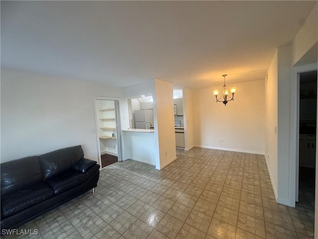 177 Santa Clara Dr Unit 177-5, Naples, FL 34104 - living room with a chandelier and baseboards