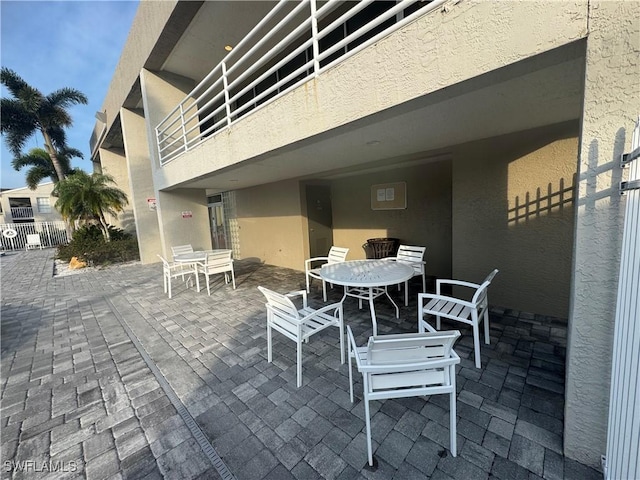 177 Santa Clara Dr Unit 177-5, Naples, FL 34104 - view of patio featuring outdoor dining area and fence