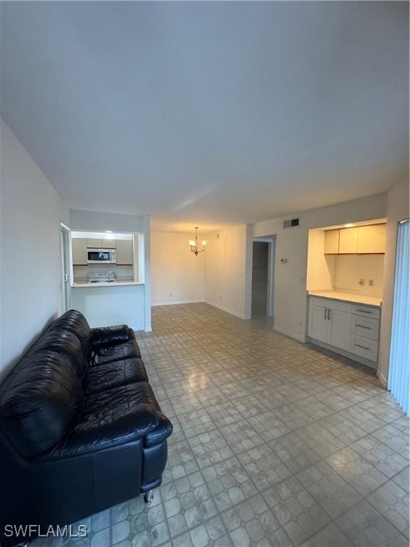 177 Santa Clara Dr Unit 177-5, Naples, FL 34104 - living area with a chandelier and baseboards