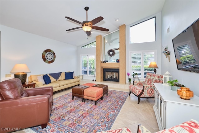 15440 Kilmarnock Dr, Fort Myers, FL 33912 - living area featuring high vaulted ceiling, a ceiling fan, a fireplace, light tile patterned floors, and visible vents