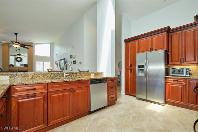 15440 Kilmarnock Dr, Fort Myers, FL 33912 - kitchen featuring a toaster, light stone countertops, stainless steel appliances, a ceiling fan, and a sink