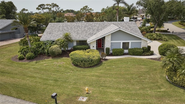 15440 Kilmarnock Dr, Fort Myers, FL 33912 - view of front of house featuring a front lawn, stucco siding, and stone siding