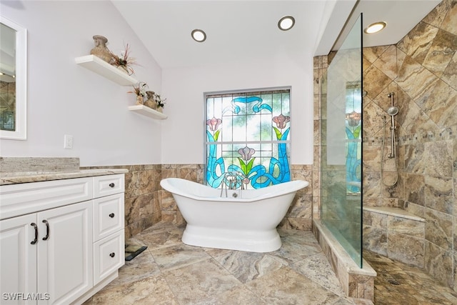 15440 Kilmarnock Dr, Fort Myers, FL 33912 - bathroom featuring tile walls, tiled shower, a soaking tub, and vanity