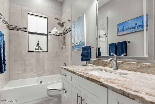full bathroom featuring tub / shower combination, toilet, vanity, and a wealth of natural light