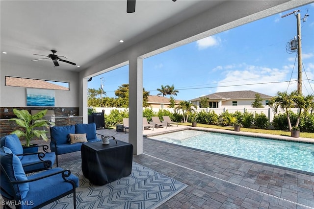 exterior space featuring outdoor lounge area, a fenced backyard, exterior kitchen, and a patio area