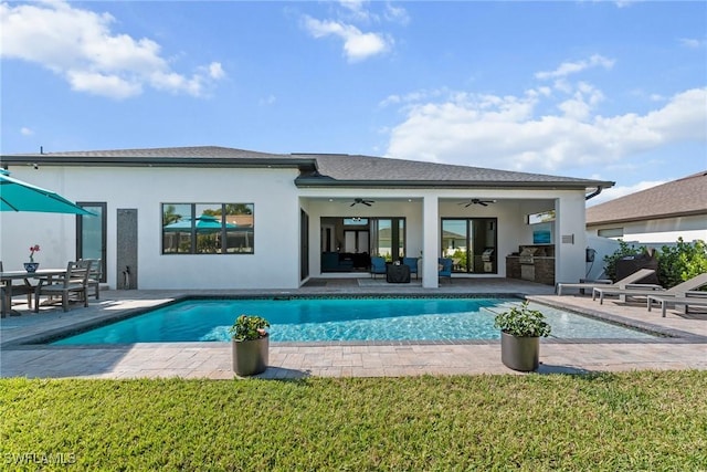 rear view of house featuring an outdoor hangout area, an outdoor pool, a ceiling fan, stucco siding, and a patio area