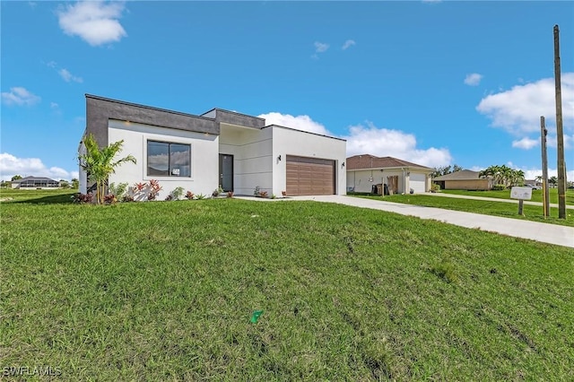 231 NW 27th Ave, Cape Coral, FL 33993 - contemporary home with stucco siding, a front lawn, concrete driveway, and an attached garage
