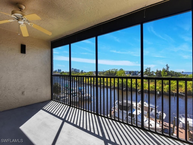 unfurnished sunroom featuring a water view