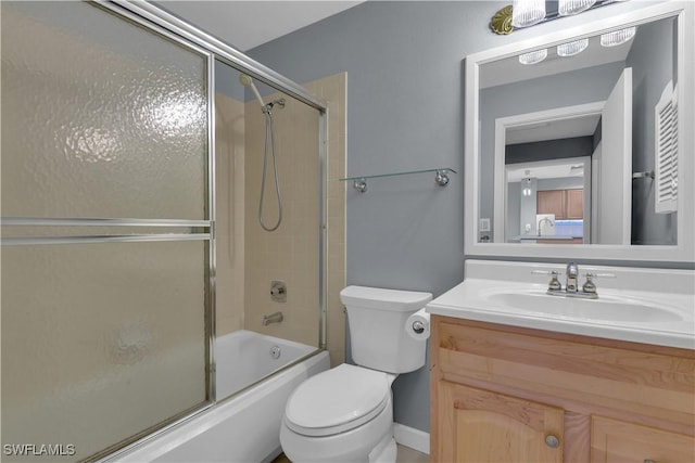 bathroom featuring vanity, toilet, and enclosed tub / shower combo