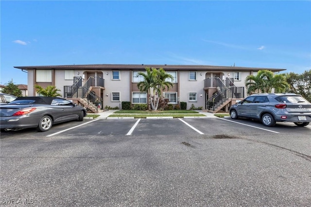 25100 Sandhill Blvd Unit 103, Punta Gorda, FL 33983 - view of property with stairs and uncovered parking