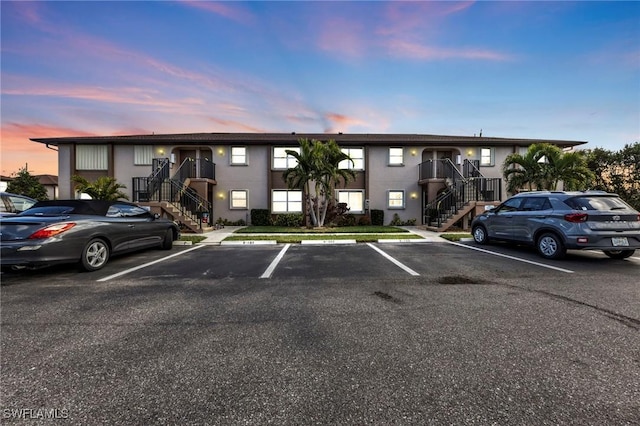 25100 Sandhill Blvd Unit 103, Punta Gorda, FL 33983 - parking at dusk with stairs and uncovered parking