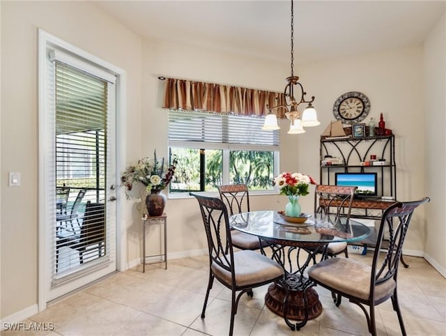 21826 Bella Terra Blvd, Estero, FL 33928 - dining space with baseboards, light tile patterned flooring, and a notable chandelier