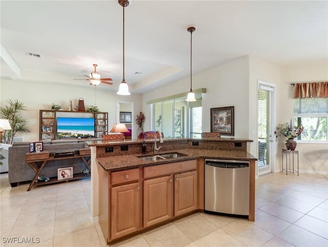 21826 Bella Terra Blvd, Estero, FL 33928 - kitchen with dishwasher, dark stone counters, a raised ceiling, a sink, and open floor plan