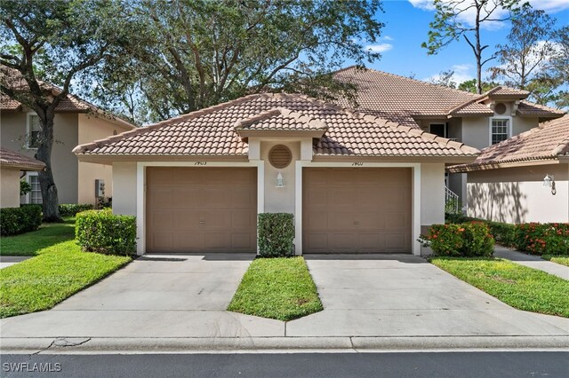 8073 Panther Trl Unit 1403, Naples, FL 34113 - mediterranean / spanish-style home with stucco siding, a garage, driveway, and a tiled roof