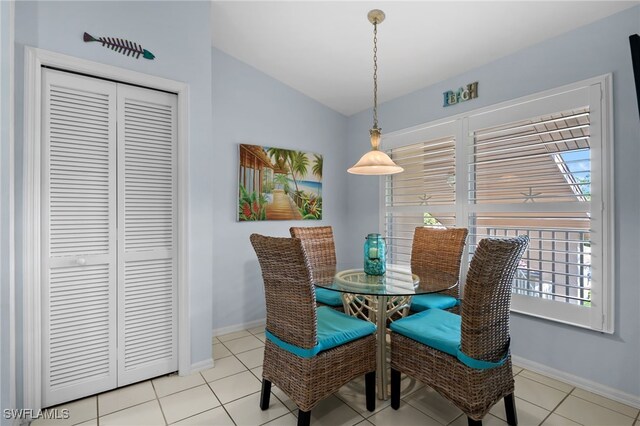 8073 Panther Trl Unit 1403, Naples, FL 34113 - tiled dining room with baseboards and lofted ceiling