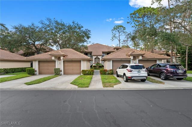 8073 Panther Trl Unit 1403, Naples, FL 34113 - view of front of property with stucco siding, a tiled roof, and concrete driveway