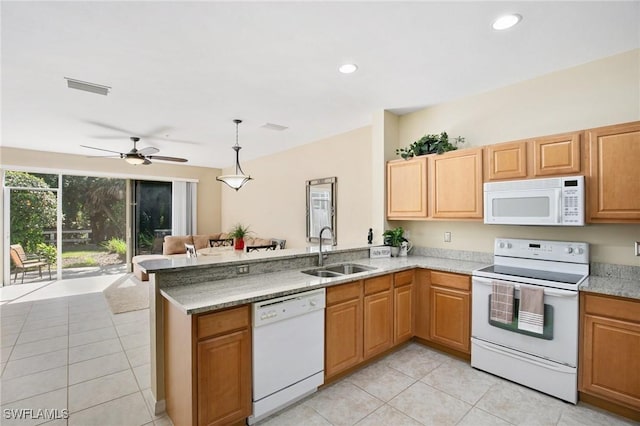 15703 Marcello Cir, Naples, FL 34110 - kitchen featuring white appliances, visible vents, a peninsula, recessed lighting, and a sink