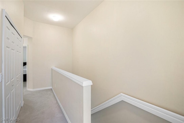 15703 Marcello Cir, Naples, FL 34110 - corridor featuring baseboards, an upstairs landing, and light colored carpet