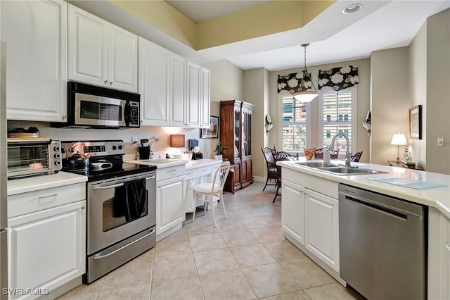 96 Vivante Blvd Unit 211, Punta Gorda, FL 33950 - kitchen with appliances with stainless steel finishes, white cabinetry, light countertops, and light tile patterned flooring