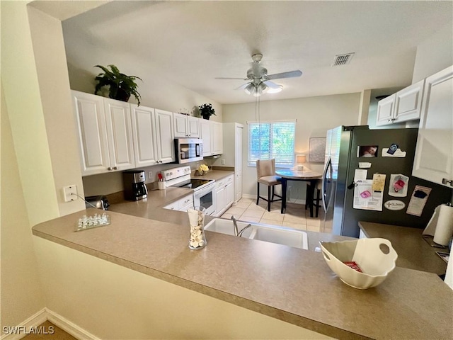 kitchen featuring a sink, a ceiling fan, white cabinetry, appliances with stainless steel finishes, and visible vents